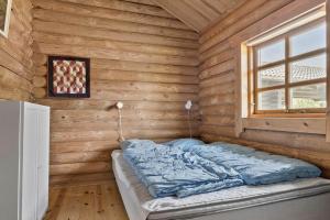 a bed in a wooden room with a window at 30118-Odder-Pouli-Nielsensvej-27 in Odder
