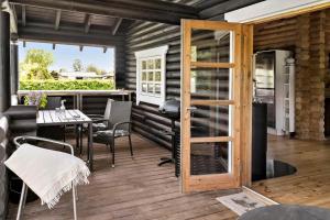 a patio with a table and chairs and a door at 30118-Odder-Pouli-Nielsensvej-27 in Odder