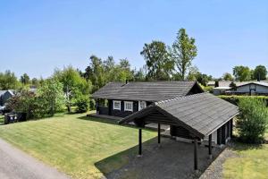 a small house with a roof in a yard at 30118-Odder-Pouli-Nielsensvej-27 in Odder +19 photos