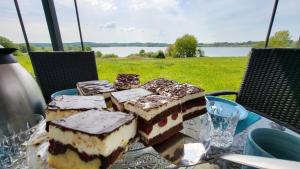 a table with several pieces of cake on it at Ferienwohnung Seeblick in Klein Upahl +15 photos