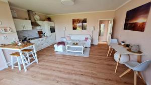 a kitchen and living room with a table and a couch at Ferienwohnung Seeblick in Klein Upahl