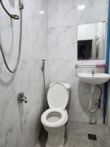 a bathroom with a toilet and a sink at TANJIL RESTAURANT & Guesthouse in Phnom Penh