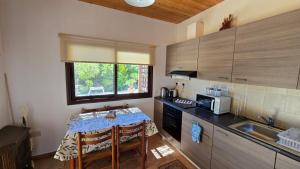 a small kitchen with a table and a sink at Secluded Garden Studio in Tala