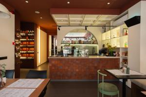 a bar in a restaurant with a counter at Artifact Apart Hotel in Tbilisi City