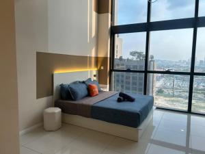 a bedroom with a bed with a view of a city at ICON CITY PETALING JAYA By WeCare in Petaling Jaya +138 photos