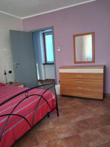 a bedroom with a bed and a dresser with a mirror at Il Borghetto in Castano Primo
