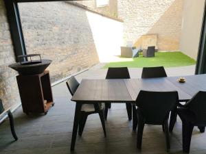 a table and chairs in a room with a large window at Chez Madame in Dijon +15 photos