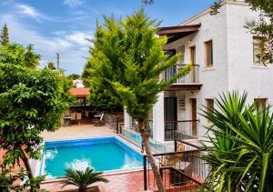 a villa with a swimming pool in front of a house at Bodrum Stone House Hotel in Bodrum City