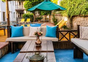 a patio with a table with a vase of flowers at Bodrum Stone House Hotel in Bodrum City