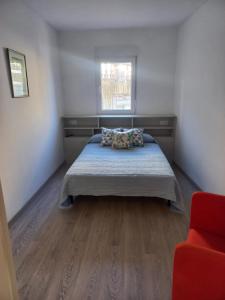 a bedroom with a bed and a window at Casa de la Soledad 2 in Lugo
