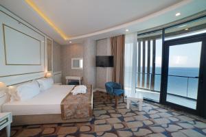 a hotel room with a bed and a view of the ocean at BLUE MUDANYA HOTEL in Bursa