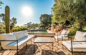 a patio with two white chairs and a pool at Ca'n Panxeta in Felanitx +13 photos