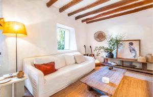 a living room with a white couch and a table at Ca'n Panxeta in Felanitx