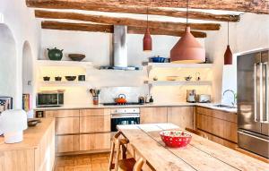 a kitchen with wooden cabinets and a wooden table at Ca'n Panxeta in Felanitx