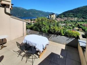 a table and chairs on a balcony with a view at Appartamento Ato La Gerbia in Cannobio