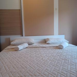 a bed with two pillows on top of it at Apartman Katić - Rental Home in Stolac +9 photos