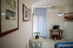 a living room with a table and a chair at Artemide B&B in Caltagirone