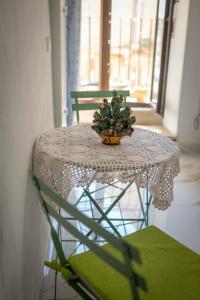 a table with a vase with a plant on it at Artemide B&B in Caltagirone