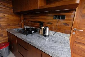 a kitchen with a counter with a coffee maker on it at The BENAWAH Villa in Tegalalang
