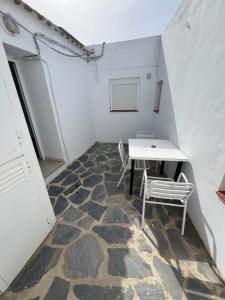 a small room with a table and two chairs at Hostal Rios in Bolonia +15 photos