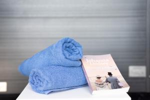 a blue towel sitting next to a book at El Alpendre in Moya +20 photos