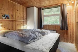 a large bed in a room with a window at 30586-Odder-Tvaeragervej-7 in Odder