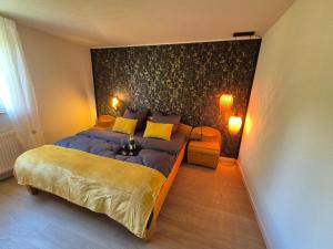 a bedroom with a large bed and a chair at Fewo Schwarzwald Von Oben - Kniebis in Freudenstadt