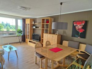 a living room with a table and a dining room at Fewo Schwarzwald Von Oben - Kniebis in Freudenstadt