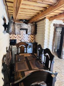 a dining room with a table and a stove at Cottage Hata Zustrich in Bukovel