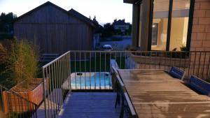 a wooden deck with a bench on a house at Maison Gabriel - Jacuzzi in Pogny