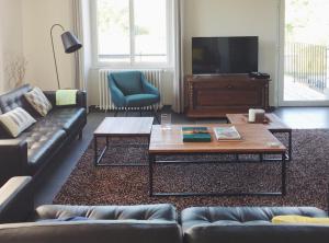 a living room with a couch and a coffee table at Maison Gabriel - Jacuzzi in Pogny