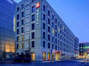 a white building with a sign on the side of it at ibis Leipzig City in Leipzig
