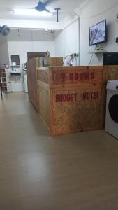 a room with a counter with a sign that reads outpost motel at 7Rooms Hotel Budget in Bandar  Pusat Jengka