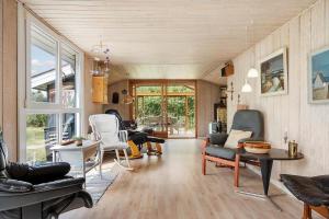 a living room with chairs and a table at 1132-Ringkobing-Hvidbjergvej-32 in Søndervig +28 photos