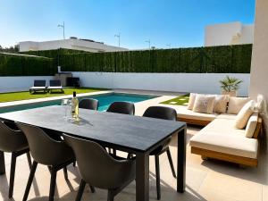 a patio with a table and chairs and a pool at Casa Calma in Calasparra