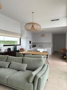 a living room with a couch and a kitchen at Casa Calma in Calasparra