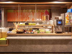 a buffet line with food on display in a restaurant at Ibis Budget Limoges Nord in Limoges