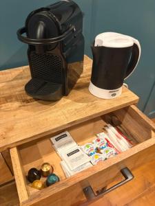 a wooden shelf with a coffee maker on it at Vue sur la colline La-Roche in Bouzais