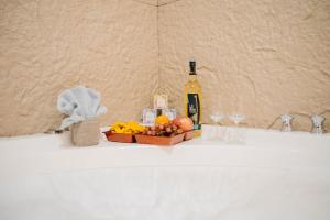 a bottle of wine and a box of fruit on a counter at G-Luxe Panabo Guesthouse - Unit B in Panabo +62 photos