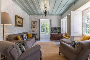 a living room with couches and a ceiling at Carcavelos Manor House by Portugal Active in Vila Verde