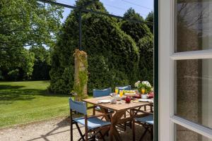 a wooden table and chairs sitting on a patio at Carcavelos Manor House by Portugal Active in Vila Verde +107 photos