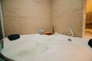 a bath tub filled with lots of water at G-Luxe Panabo Guesthouse - Unit B in Panabo
