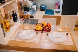 a table with two plates and a tray of fruit at G-Luxe Panabo Guesthouse - Unit B in Panabo