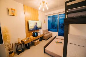 a small room with a bed and a tv in it at G-Luxe Panabo Guesthouse - Unit B in Panabo