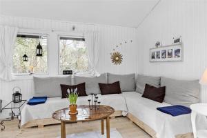 a living room with a white couch and a table at 1176-N-Hundested-Brune-Bakke-1 in Hundested