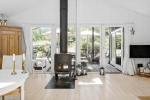 a living room with a wood stove in it at 1176-N-Hundested-Brune-Bakke-1 in Hundested