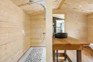 a wooden bathroom with a sink and a shower at 1176-N-Hundested-Brune-Bakke-1 in Hundested +26 photos