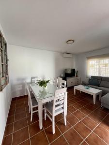 a living room with a table and chairs and a couch at Casa caminito 2 in Zahora