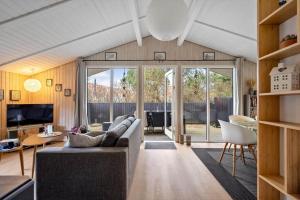 a living room with a couch and a tv at 239-Ringkobing-Vestklitvej-32 in Klegod