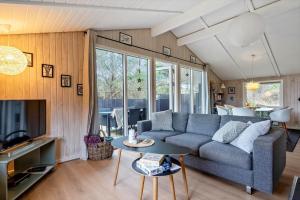 a living room with a couch and a table at 239-Ringkobing-Vestklitvej-32 in Klegod +31 photos